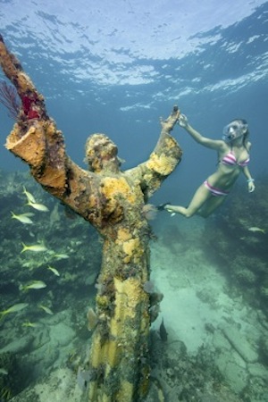 Christ of the Deep statue, symbolizing peace of mankind and resting in nearly 25 feet of water, is located at Key Largo Dry Rocks, in waters adjacent to John Pennekamp Coral Reef State Park